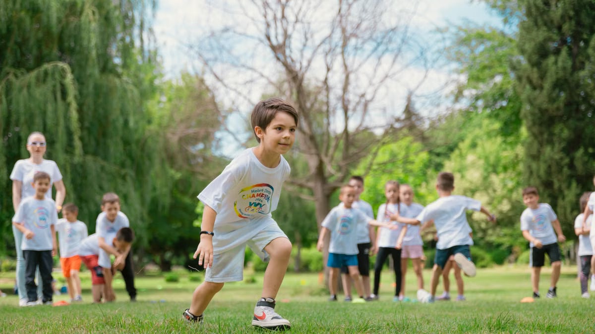 Group of children enjoying outdoor playtime in a green park during summer.